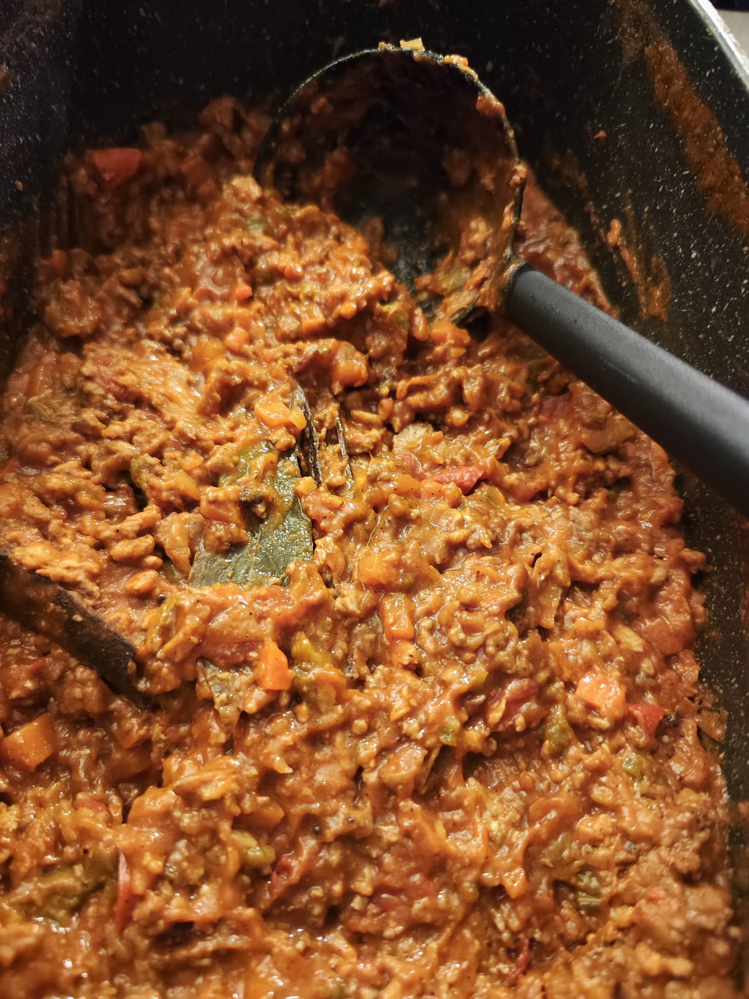 The sauce after a long simmer — thick, rich, everything melded together