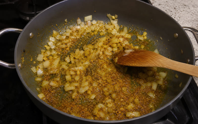 Curry powder blooming into the onion and garlic base