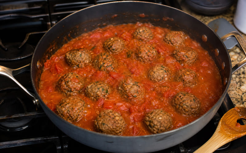 Meatballs simmering in tomato sauce