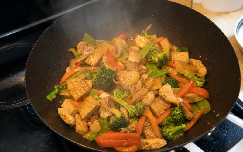 Vegetables flashing through the hot wok